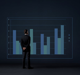 Businessman standing over column diagram background. Business, office, career, job concept.