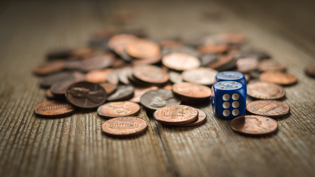 Dices and coin stack on wooden table