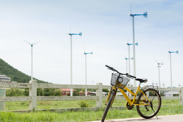 Fototapeta na wymiar beautiful landscape image with Windturbine and yellow bike