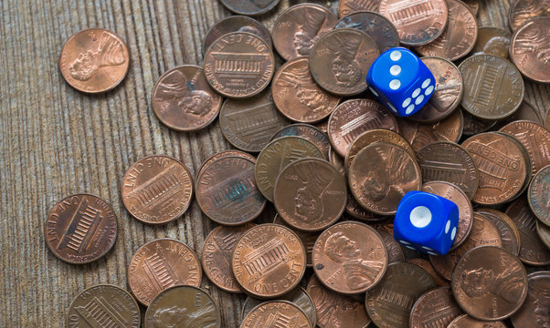 Dices and coin stack on wooden table