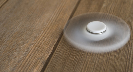 Fidget spinner swirling on wooden table