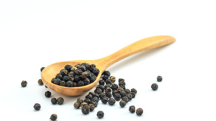 Peppercorn with wooden spoon on white background. Composition isolated over the white background.
