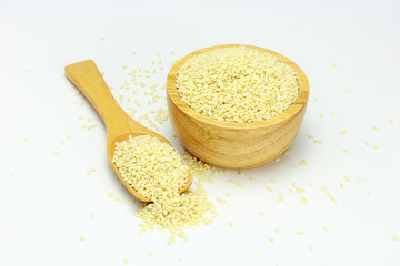 White Sesame Seeds  in wooden bowl and spoon on white background. Composition isolated over the white background.