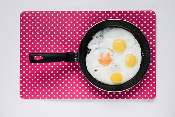 Delicious healthy simple breakfast meal made of eggs on a frying pan ready.