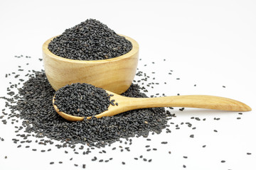 Black Sesame Seeds  in wooden bowl and spoon on white background. Composition isolated over the...