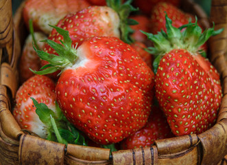 Red ripe strawberries in a wicker basket