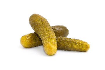 Three marinated pickled cucumbers isolated on white background