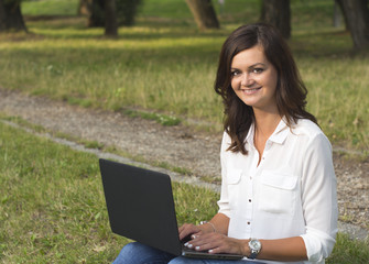 Young woman using a laptop in the nature