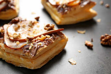 Delicious pastry with chocolate, pear and nuts, closeup