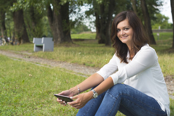 Young woman using a tablet in the nature