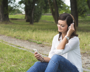 Young woman hearing music in the nature