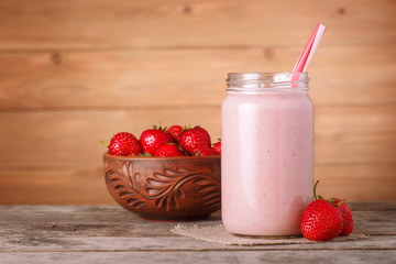 strawberry milkshake on wooden background