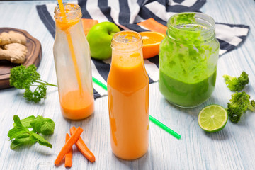 Fresh smoothies with ingredients on table