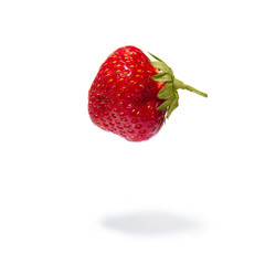 Fresh levitating strawberry isolated on white background