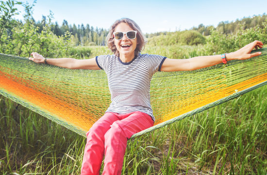 Young Beautiful Happy Woman On A Hammock In A Summer Forest