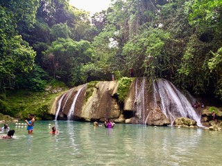 Relaxation and adventure at beautiful Reach Falls, a tropical eco waterfall attraction in Jamaica (Caribbean) in the Portland Parish close to Long Bay with cascades, pools and lush greenery