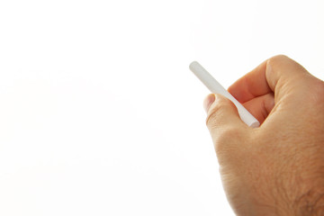A man holding white chalk isolated on a white background. This image can be used to represent teaching or education. 