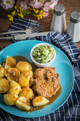 Braised meat in sauce served with boiled potatoes.