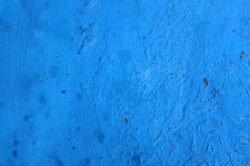 Blue uneven painting on the wall. Background