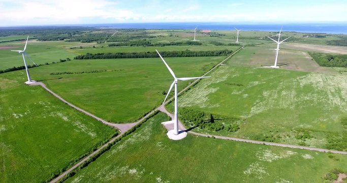 Aerial view at onshore wind farm with group of horizontal axis wind turbines. Lands near Gulf of Finland, Estonia