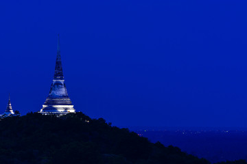 White pagoda on top of hill.