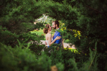 Naklejka na ściany i meble The bride and groom in the bushes.
