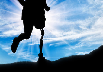 Man with prosthetic leg running up the hill