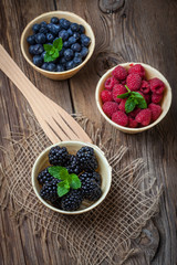 Blackberries, raspberries and blueberries in a waffle bowls.