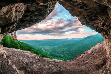 Beautiful scenic summer landscape view of Mezmay village from inside a weird rocky grotto in...