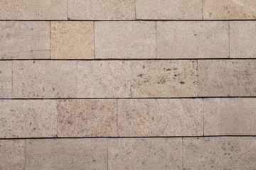 Obraz premium Pale brown brick or stone wall, useful texture for background