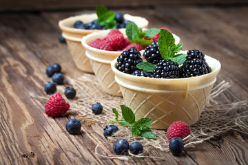 Blackberries, raspberries and blueberries in a waffle bowls.
