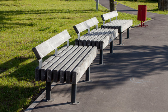 Park benches with trashcan, part of city infrastructure, comfortable relax
