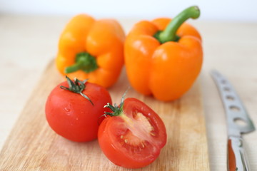 orange bell pepper, tomato on Board