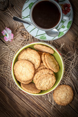 Stack of freshly baked oat biscuits in a bowl.