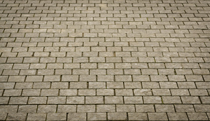 Stone pavement texture. Granite cobblestoned pavement background.