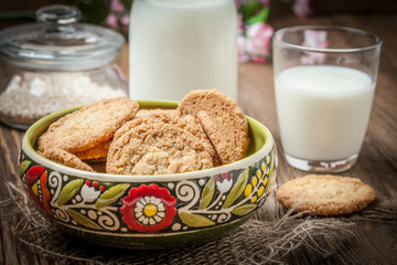 Stack of freshly baked oat biscuits in a bowl.