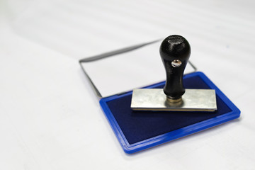 Stamp pump with the blue ink place on the white paper in selective focus and copy space for your text.