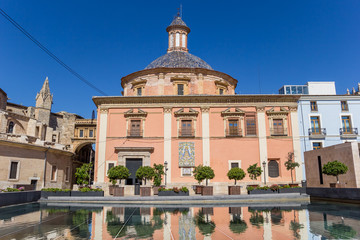 Fototapeta na wymiar Colorful Basilica de la Virgen with reflection in the water in Valencia