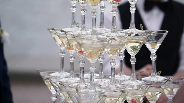 Pyramid of glasses with champagne outdoors