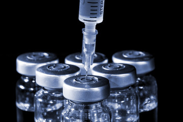 Glass Medicine Vials and Syringe. Tinted image.