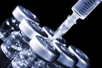 Glass Medicine Vials and Syringe. Tinted image.