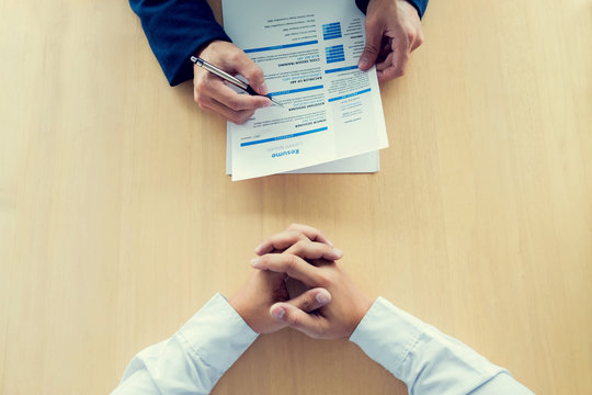 Executive reading a resume during a job interview of candidate