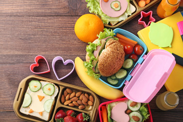 School lunch in boxes on brown wooden table