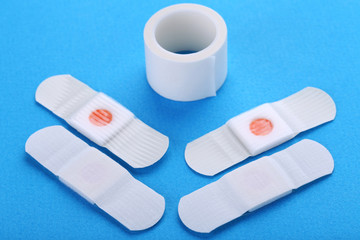 Medical plasters on blue background