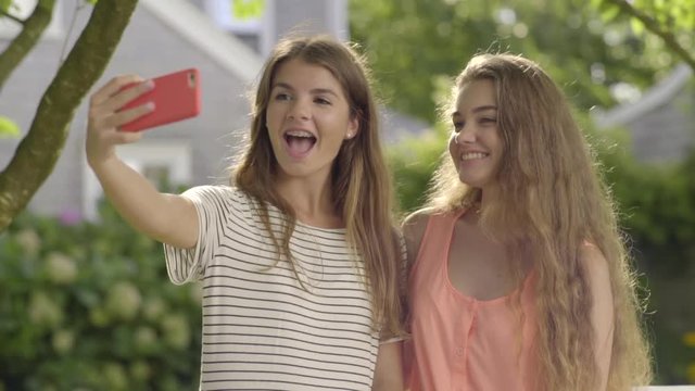 Teenage Girls Take Cute Selfies Together In Beautiful Neighborhood
