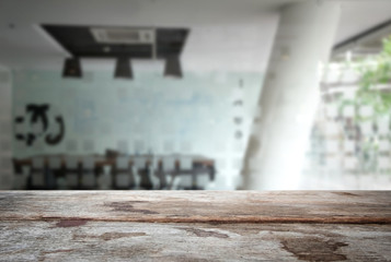 Selected focus empty old wooden table and meeting room or office work blur background image. for your photomontage or product display