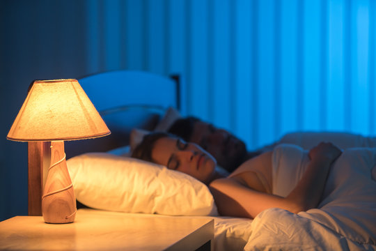 The Sleeping Couple On The Bed. Night Time