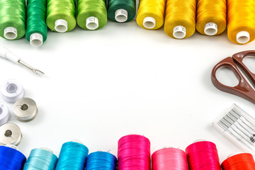 Threads spools colorful and accessories needle, bobbin, seam ripper, scissors