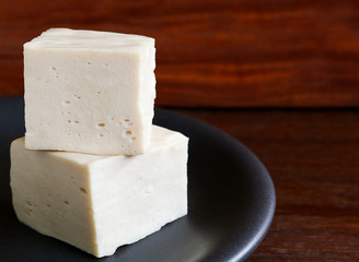 soy tofu or bean curd, Vegetarian food on wooden background.
