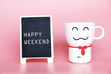 Happy Weekend text on blackboard and Coffee cup smiling 